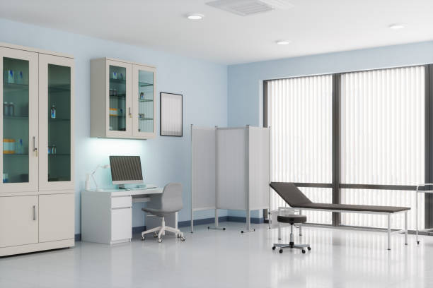 Doctor’s office with desk, cabinets and examination table.